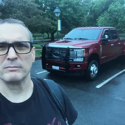 Thad standing in front of Big Red, his brother's truck