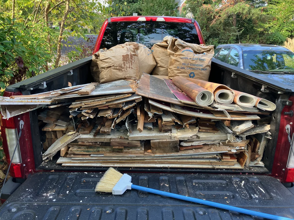 Truck bed loaded with demolition debris from a foyer remodel