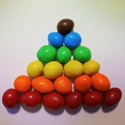 Peanut M&Ms arranged in a color gradient pyramid