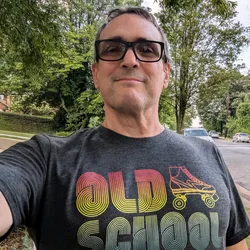 Thad wearing an Old School roller skate t-shirt outdoors