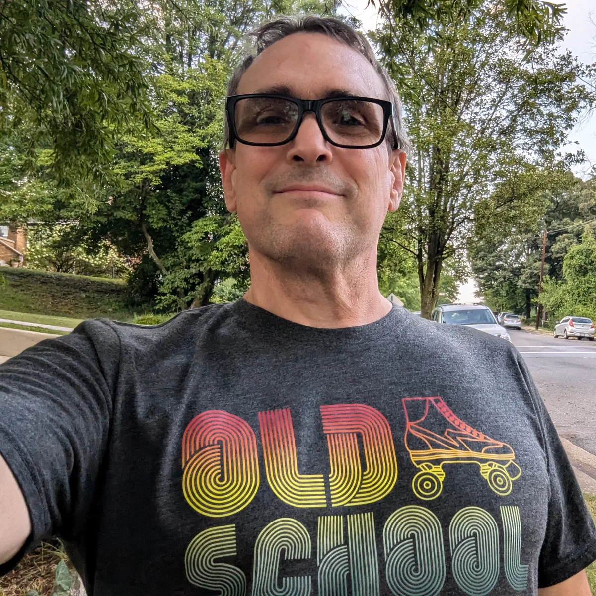 Thad wearing an Old School roller skate t-shirt outdoors