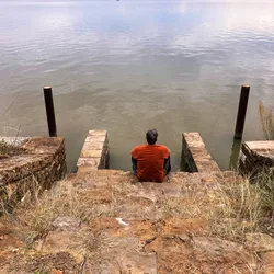 Thad sitting at the bottom of the stone staircase at Lake Brownwood