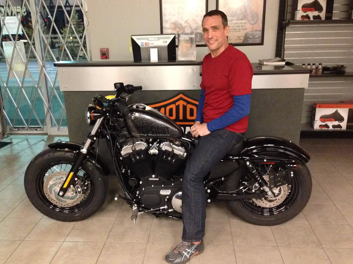 Thad sitting on his new Harley Davidson Forty-Eight at the dealership