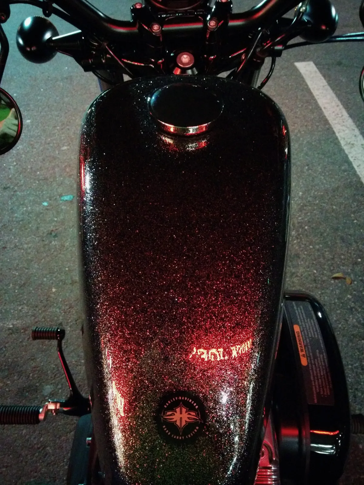Close-up of Miss Scully's sparkly peanut tank glowing red at night