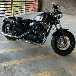 Thad's black Harley Davidson Forty-Eight parked in a garage with yellow lane markings.