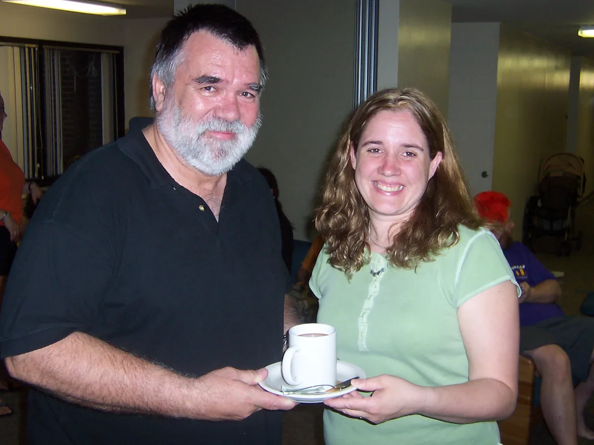 Chuck Baird and Jolynn holding a gift