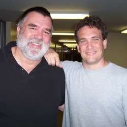 Chuck Baird and Thad standing together with arms around each other