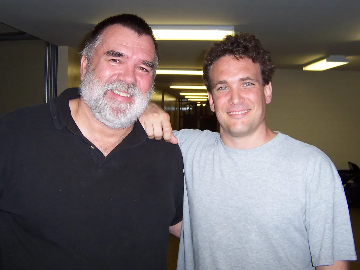 Chuck Baird and Thad standing together with arms around each other