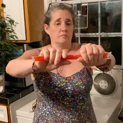 Jolynn holding a Fla-Vor-Ice pop, about to snap it in half