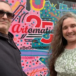 Thad and Jolynn standing in front of a colorful Artomatic mural in Washington, D.C.