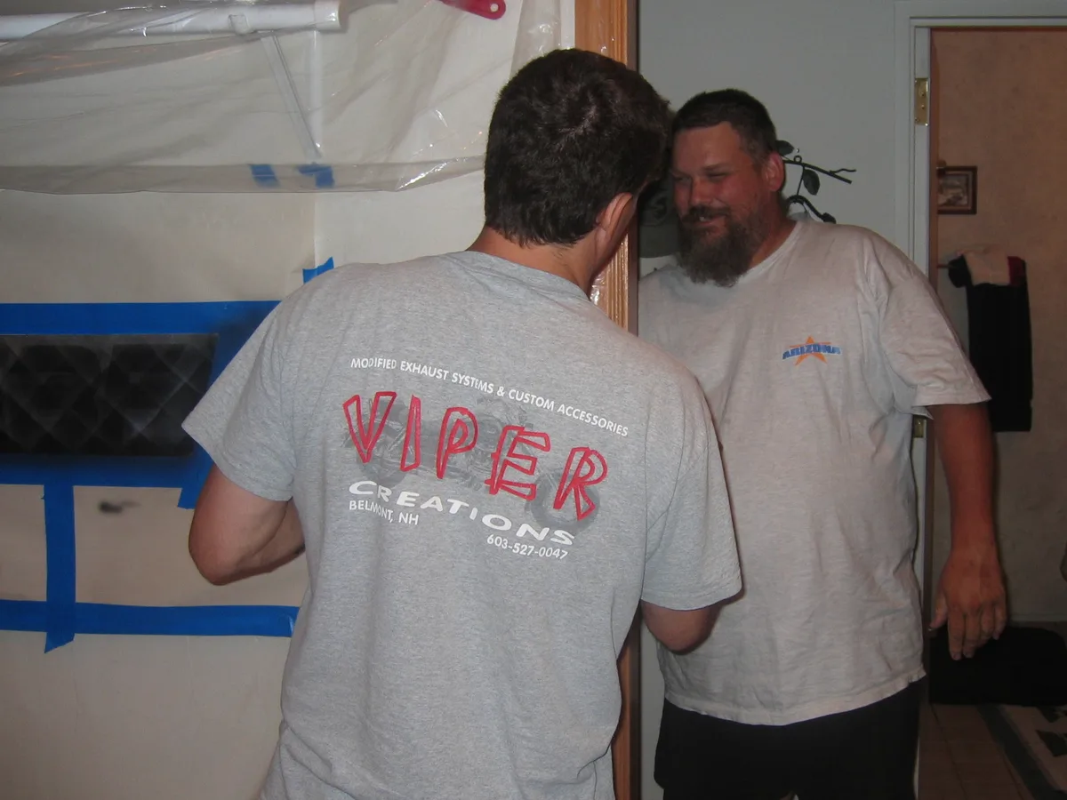Thad blocking his brother Bill from seeing the sign in progress