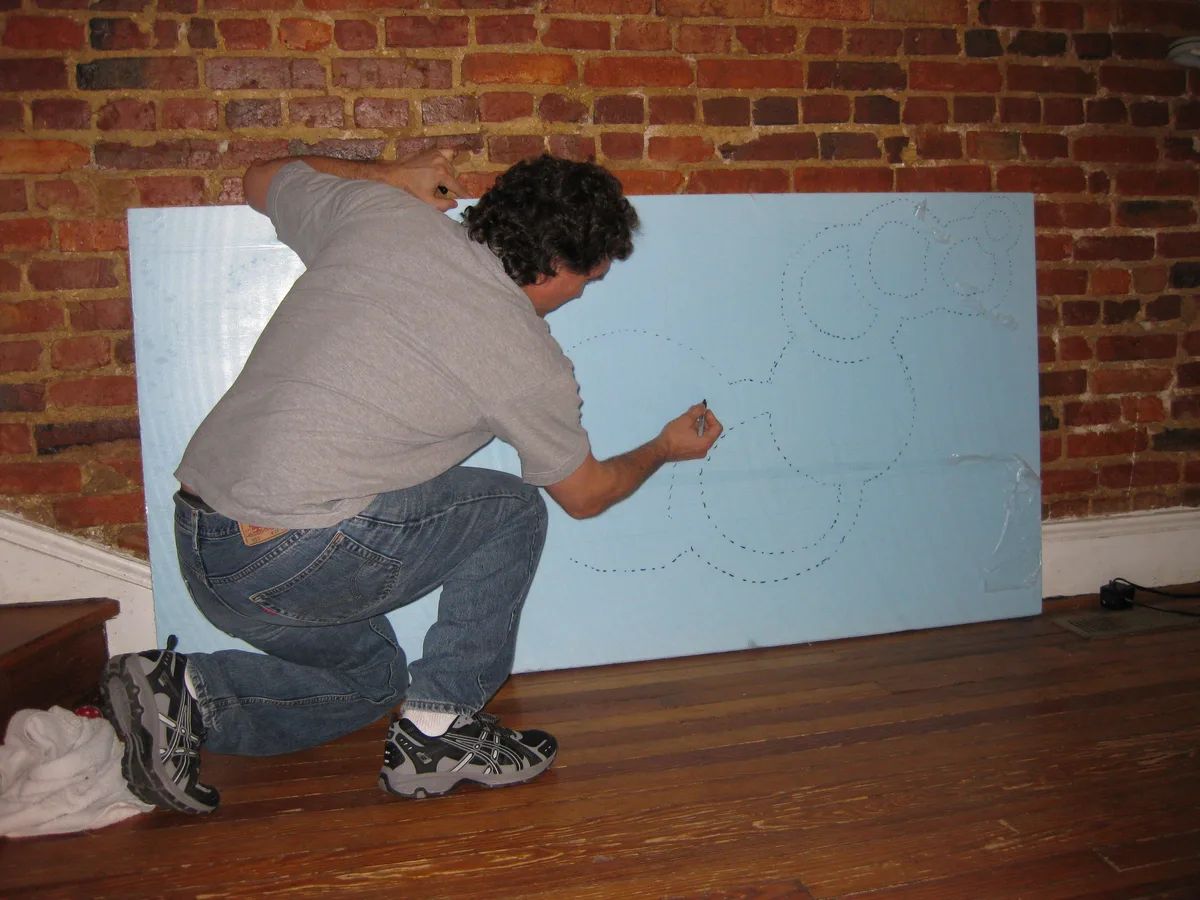 Thad sketching the circle layout for Dried Up onto blue foam board before cutting.