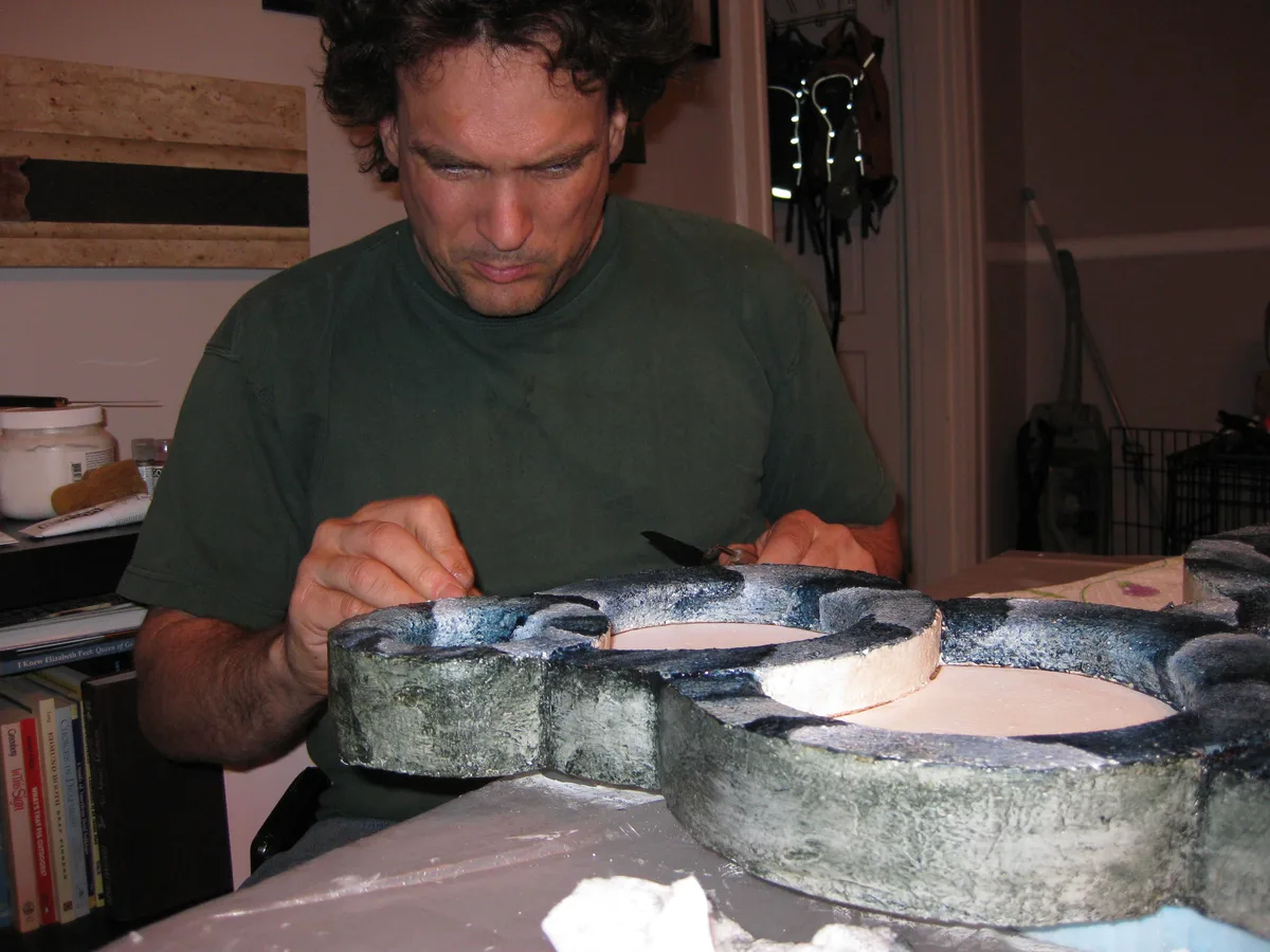 Thad painting the rims of the foam circles for Dried Up in grayish blue tones.