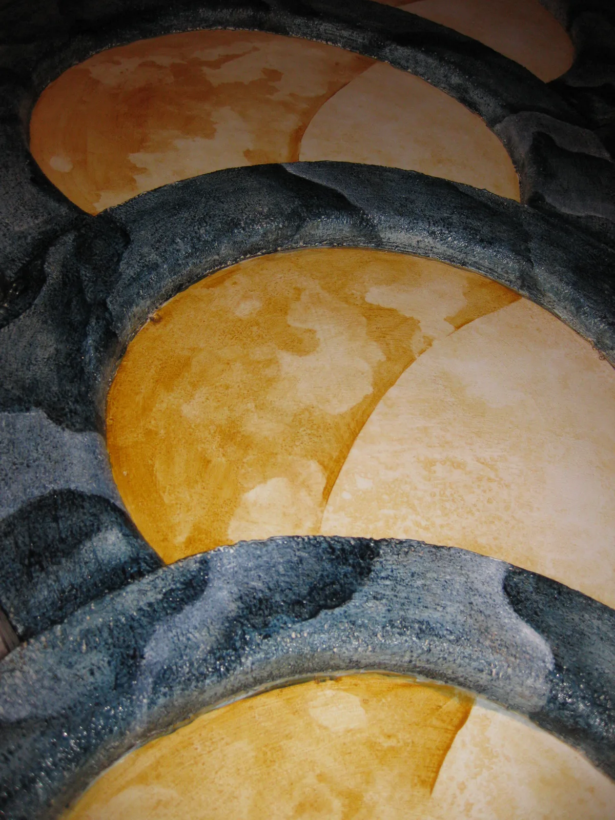 Detail shot of the golden centers being painted inside the grayish blue rims.