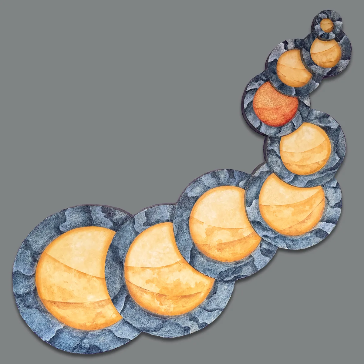 A wall sculpture titled Dried Up, showing overlapping circular puddle shapes cut from foam board and painted in blue-gray and gold tones.