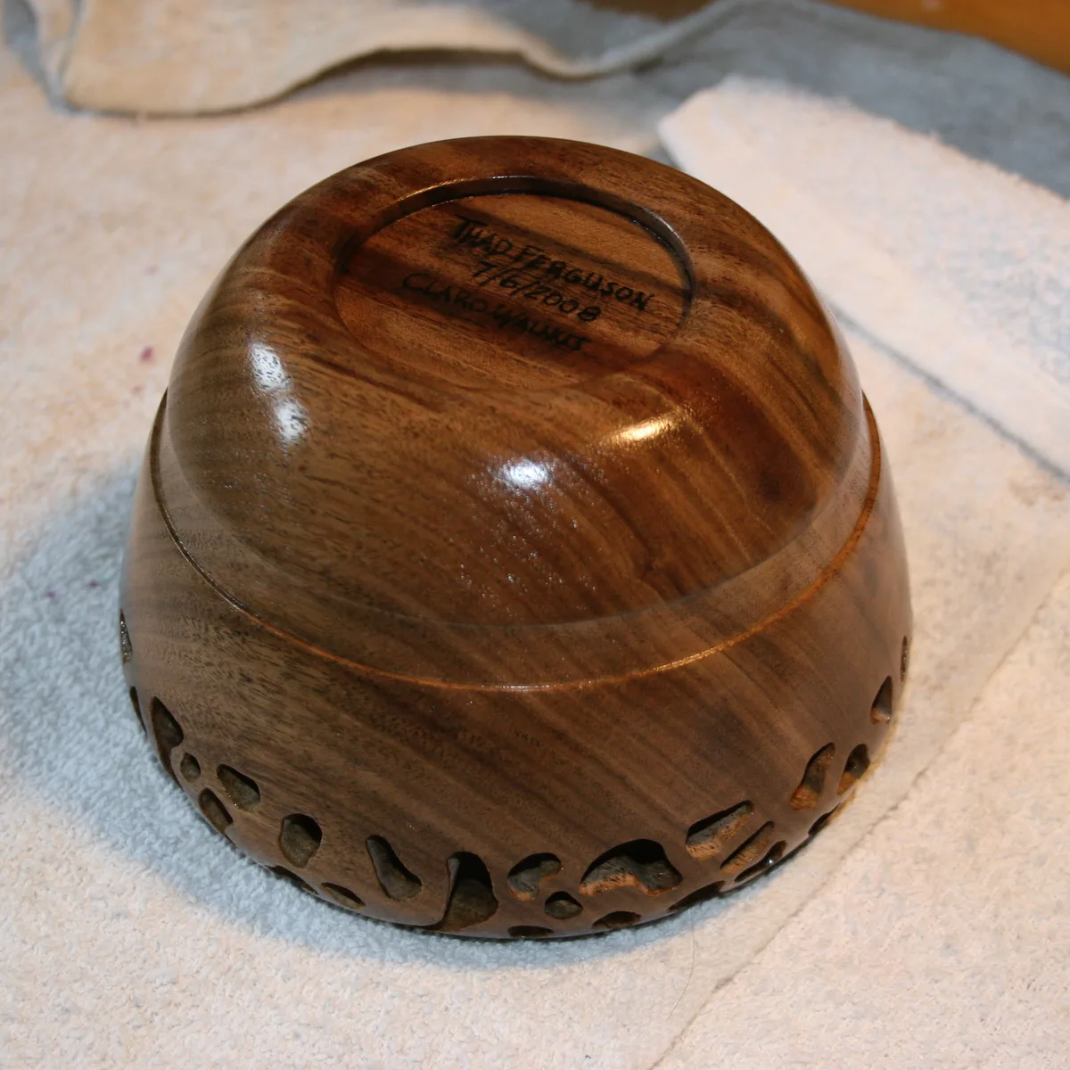 Bottom of the finished walnut bowl showing the signature