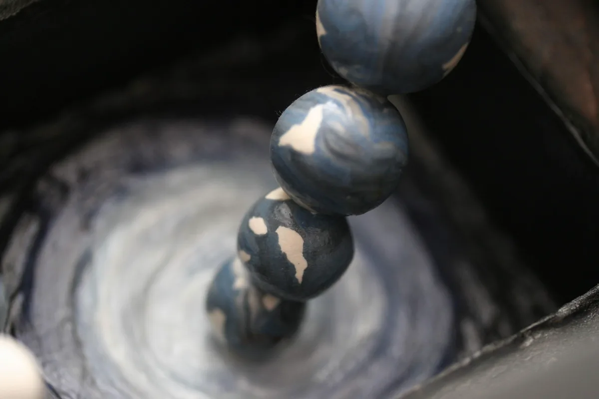 Detail shot of the clay beads leading down toward the painted swirl in Subconscious at Work.