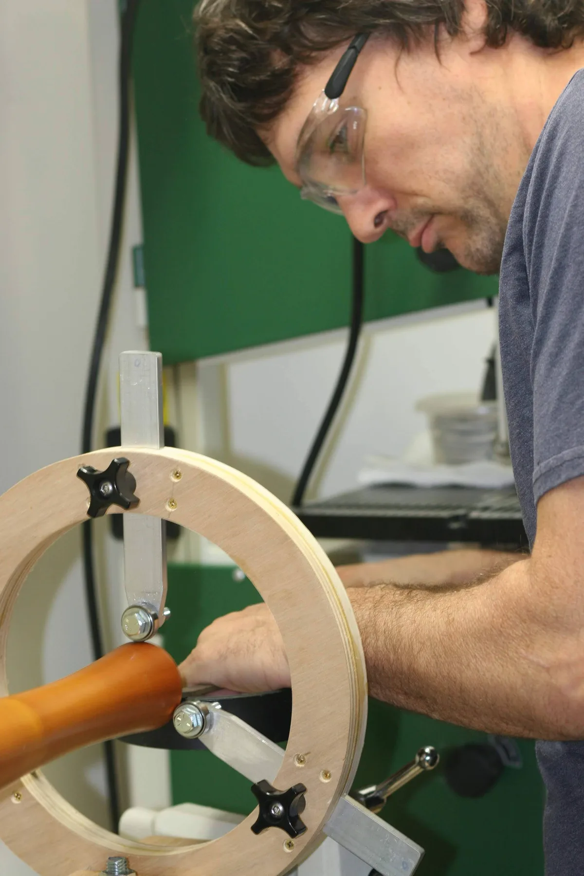 Thad cutting the wood stand while it spins on the lathe