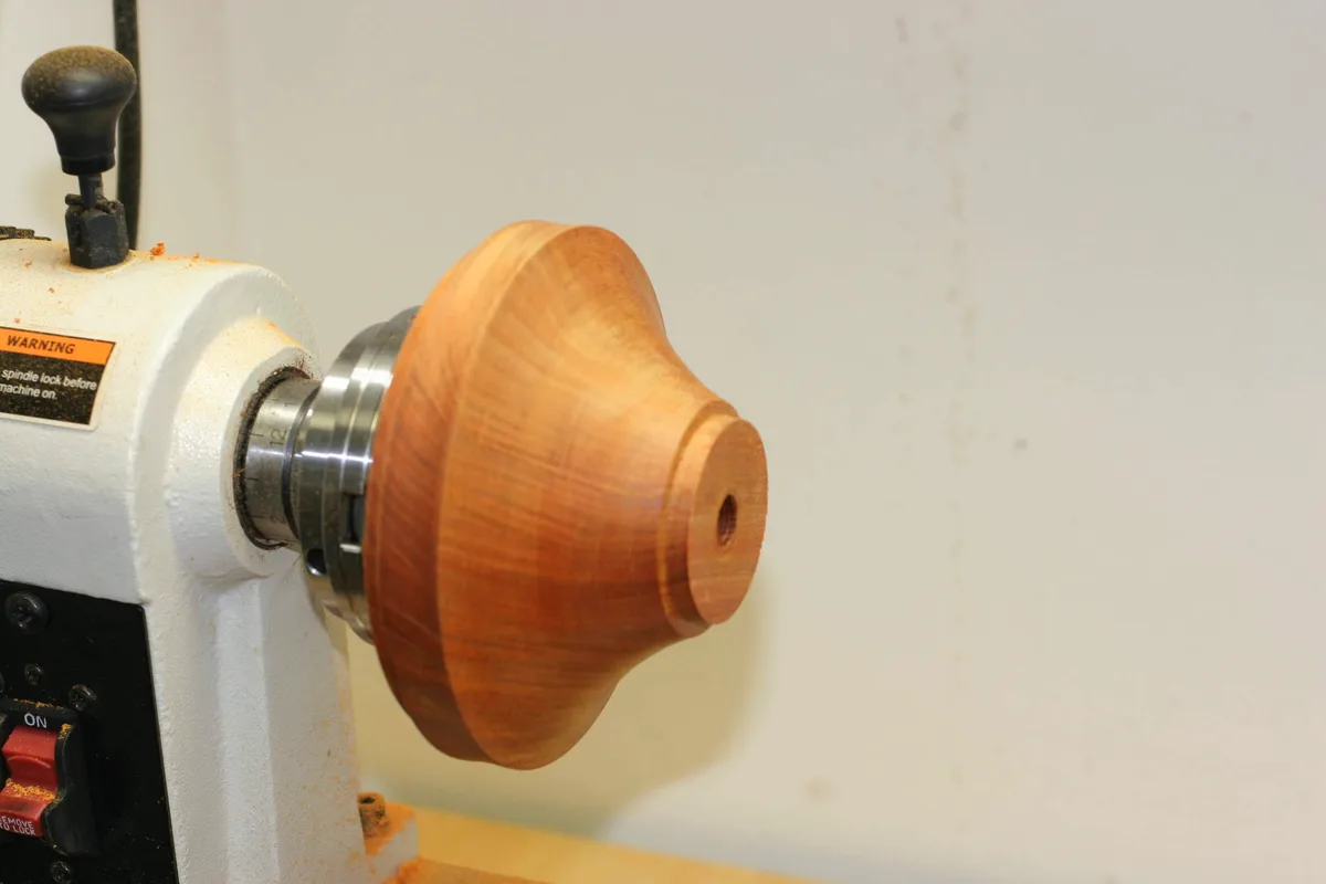 Wood base of the stand shaped on the lathe, before polishing